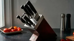 Un taco de cuchilos en una bonita cocina decorada con tomates en la encimera